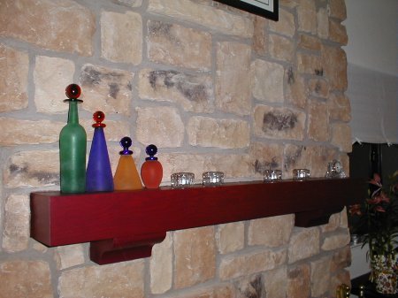 Repainted mantel with Italian glass bottles.